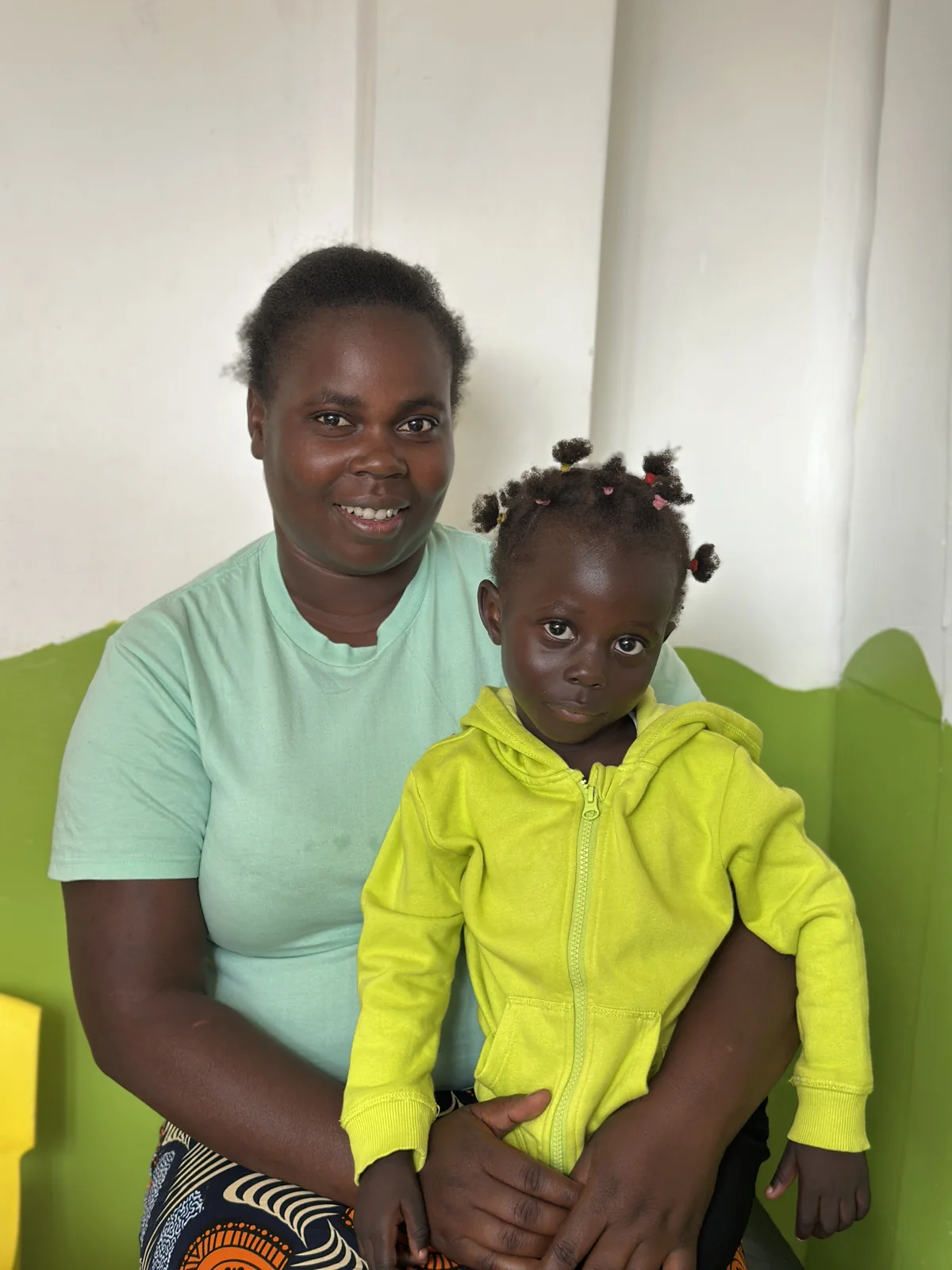 A caregiver and child together in the familiar Little Heaven room