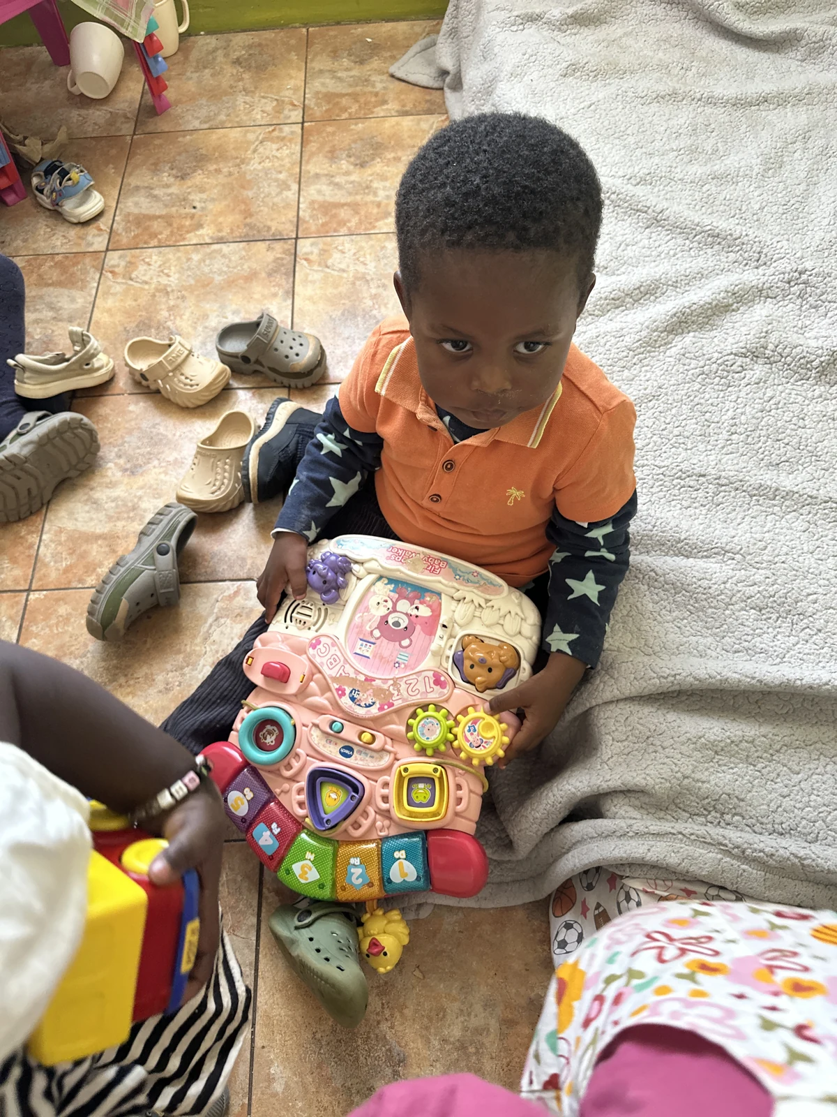Children exploring toys together around a table
