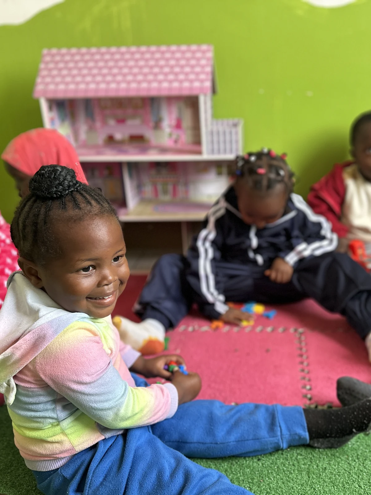 Children exploring toys together around a table at Little Heaven