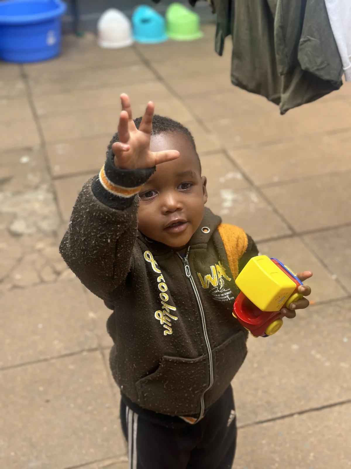 A young child playing outside Little Heaven
